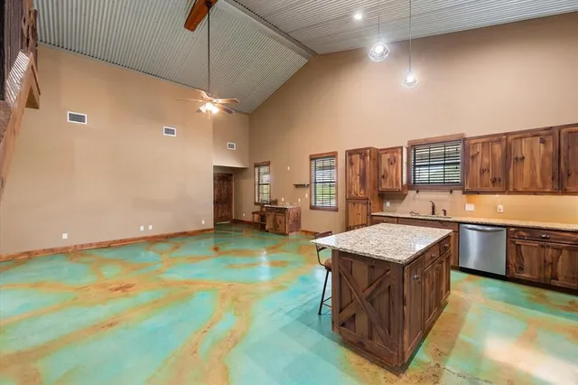 a kitchen with stainless steel appliances granite countertop a sink and stove