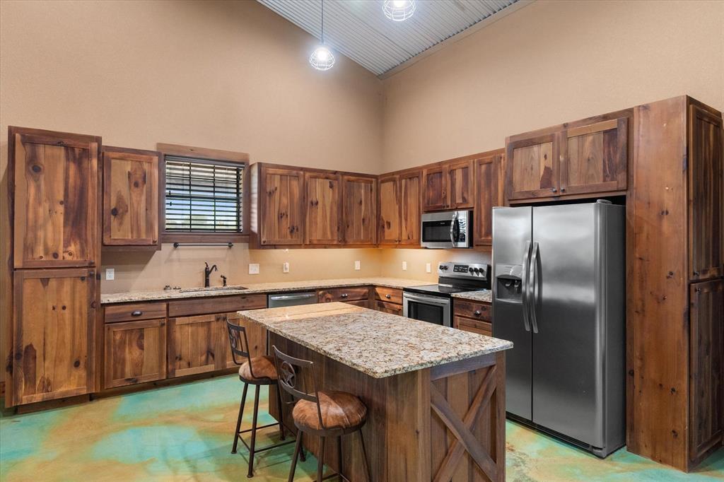 845 North Cardinal Road Azle, TX 76020 - Photo 6 of 37 a kitchen with kitchen island a counter space a sink appliances and cabinets