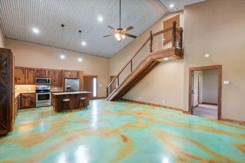 a kitchen with stainless steel appliances kitchen island a refrigerator and a sink