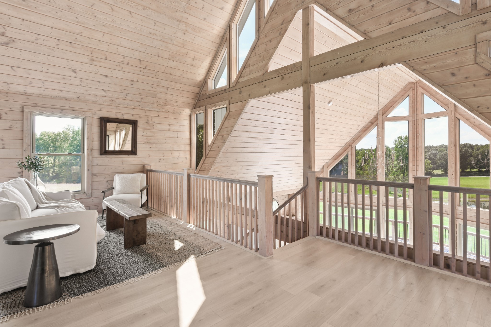 7720 Smith Road Primm Springs, TN 38476 - Photo 21 of 37 a living room with couches and a dining table with large windows