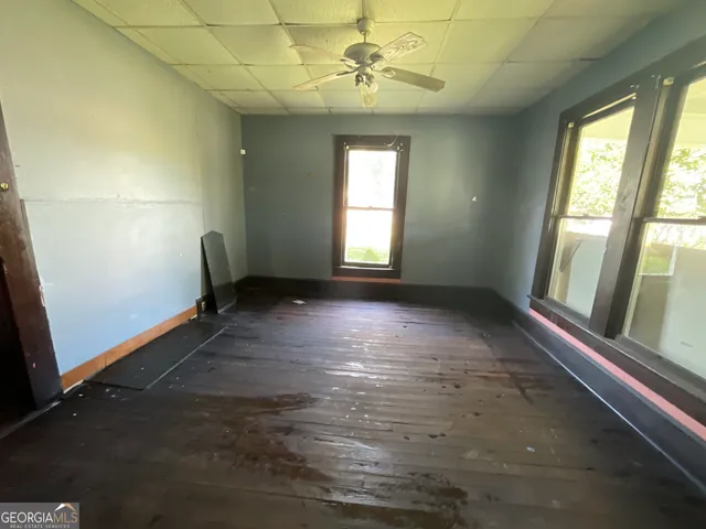 wooden floor in an empty room with a window