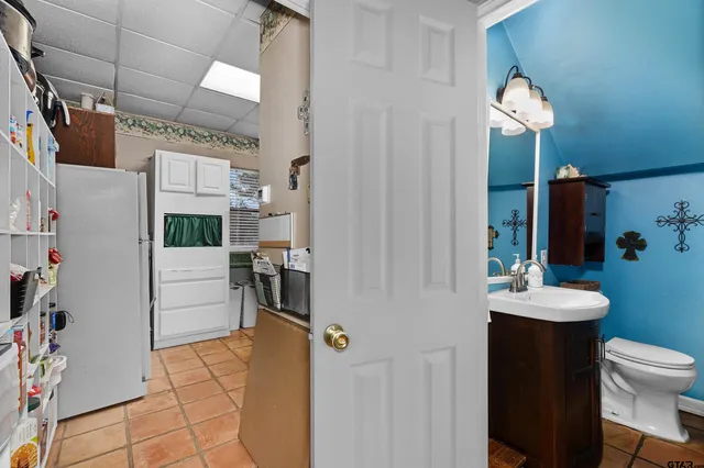 a bathroom with a sink a toilet and mirror