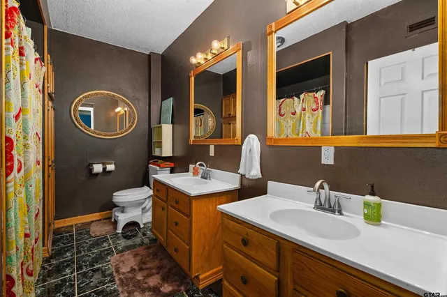 a bedroom with a bed and a ceiling fan