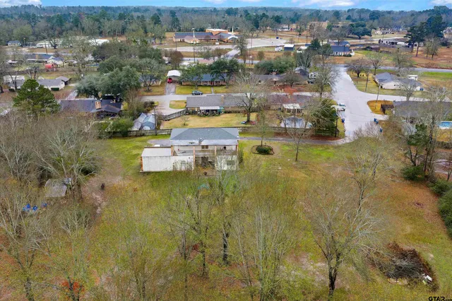 an aerial view of residential houses with outdoor space and swimming pool