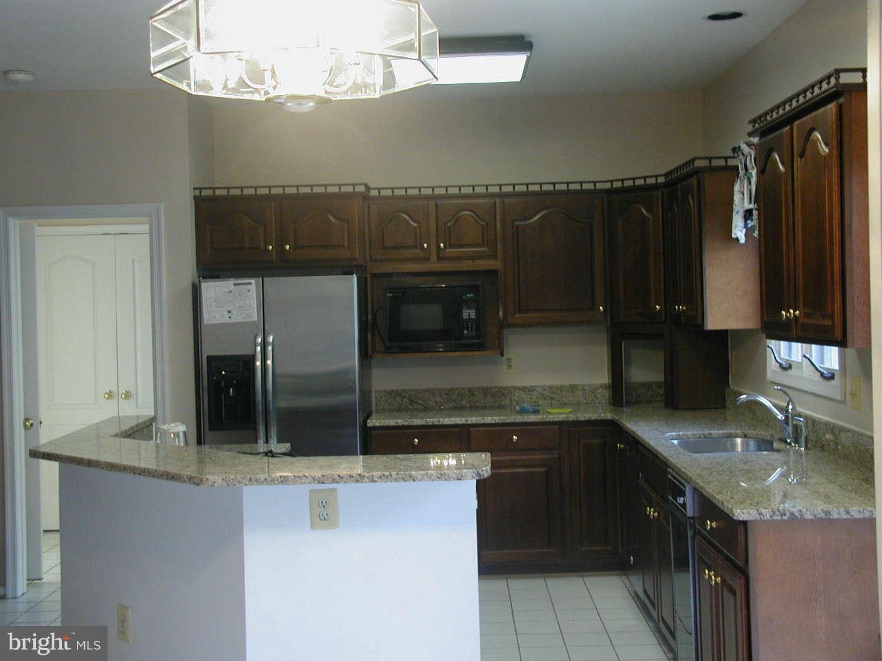 2206 Central Avenue Vienna, VA 22182 - Photo 8 of 20 a kitchen with granite countertop a sink and cabinets