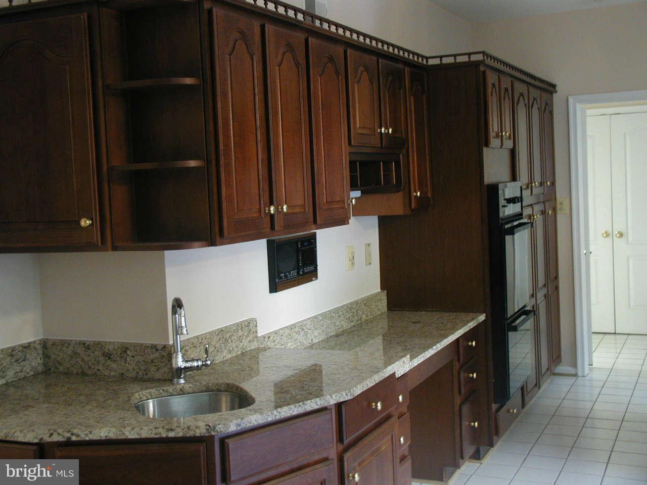 2206 Central Avenue Vienna, VA 22182 - Photo 9 of 20 a kitchen with granite countertop a refrigerator and a sink