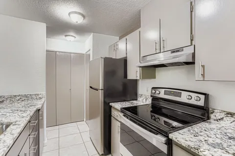 a kitchen with a stove and a refrigerator