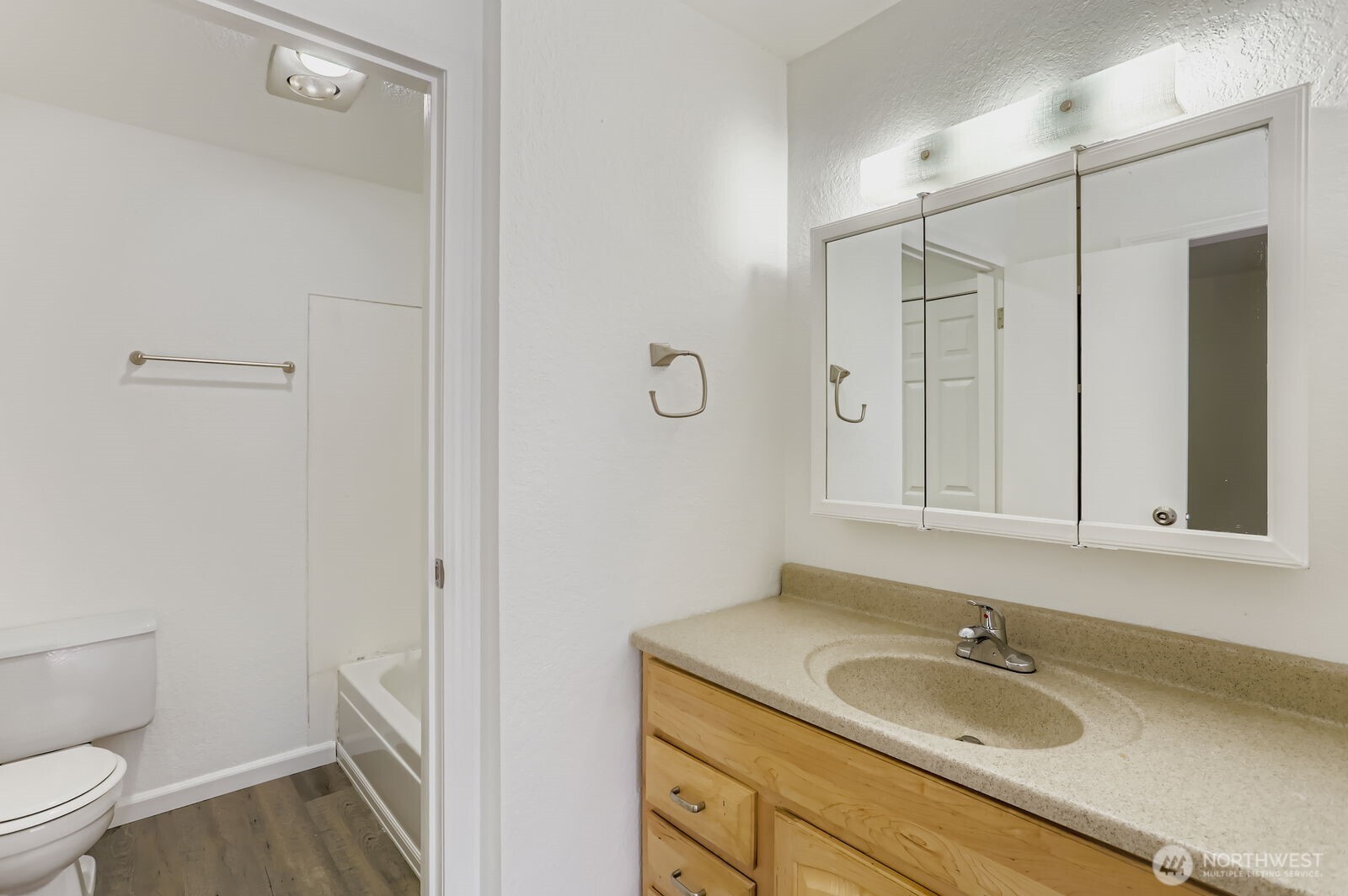 830 Kirkland Way, Unit 204 Kirkland, WA 98033 - Photo 17 of 27 a bathroom with a granite countertop sink a toilet and a mirror