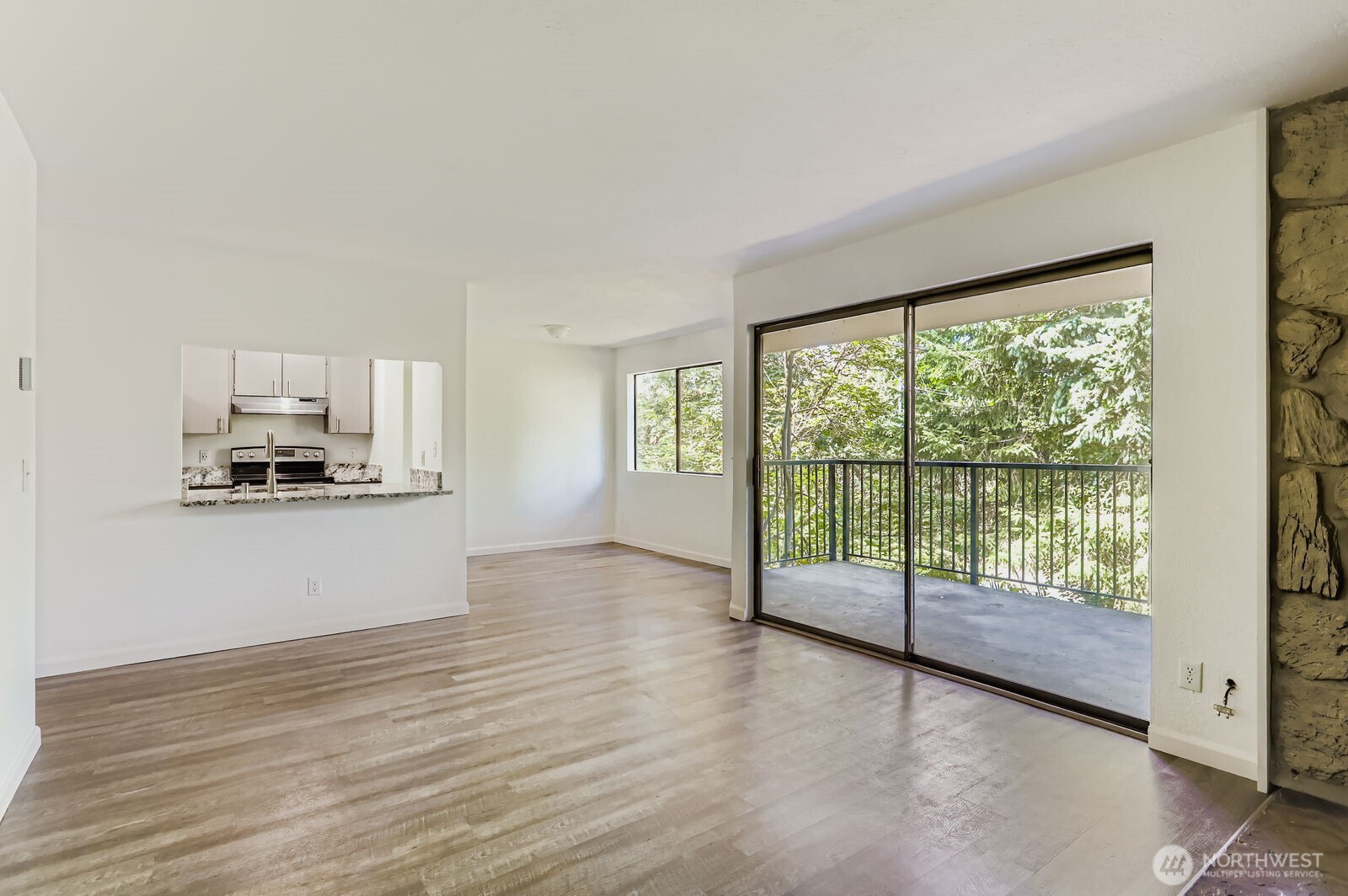 830 Kirkland Way, Unit 204 Kirkland, WA 98033 - Photo 8 of 27 a view of a kitchen with wooden floor and electronic appliances