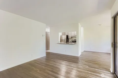 a view of a kitchen with a sink and a refrigerator