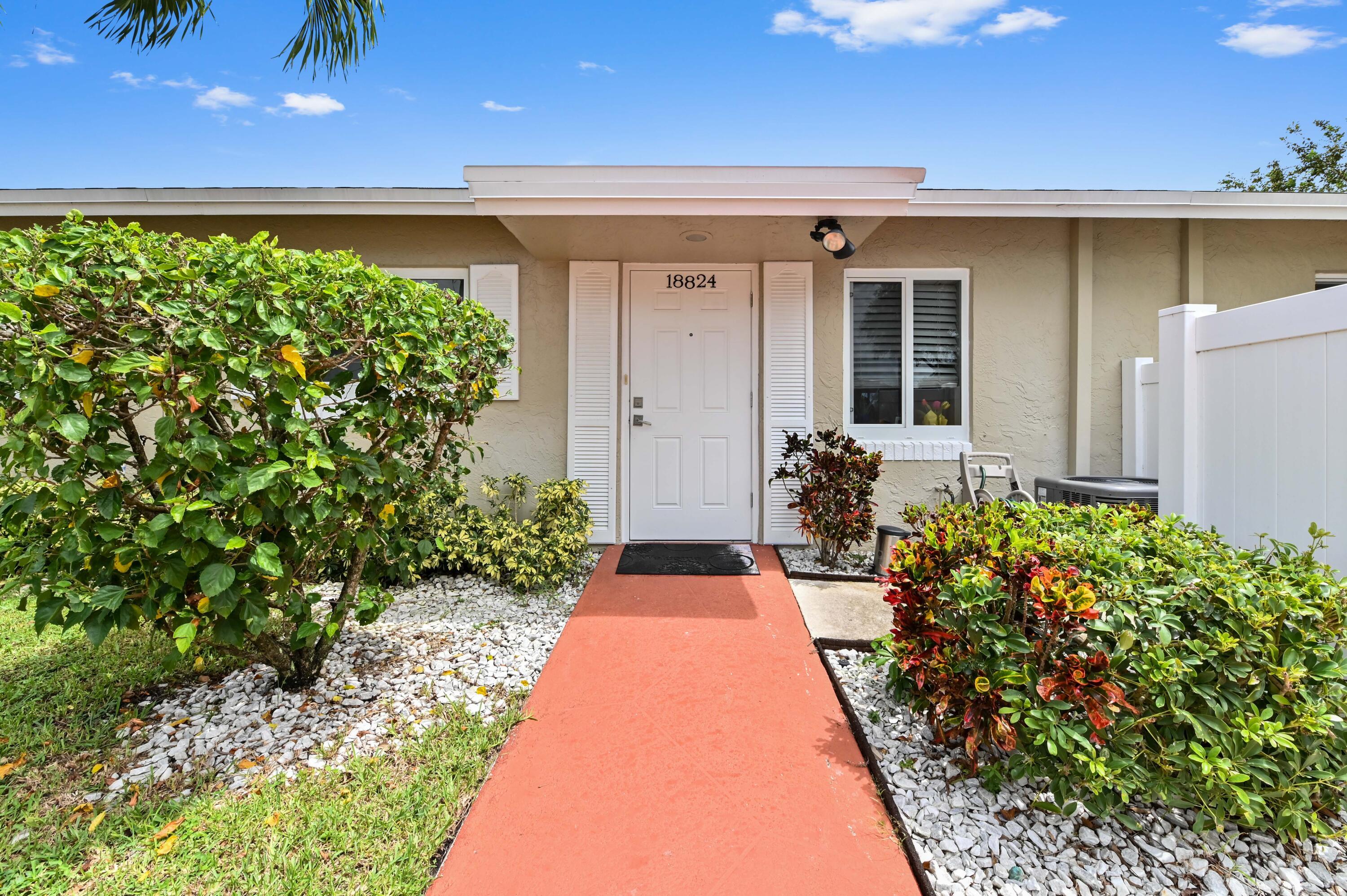 18824 Argosy Drive, Unit C Boca Raton, FL 33496 - Photo 1 of 18 a front view of a house with a yard