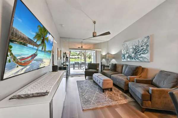 a living room with furniture wooden floor and window