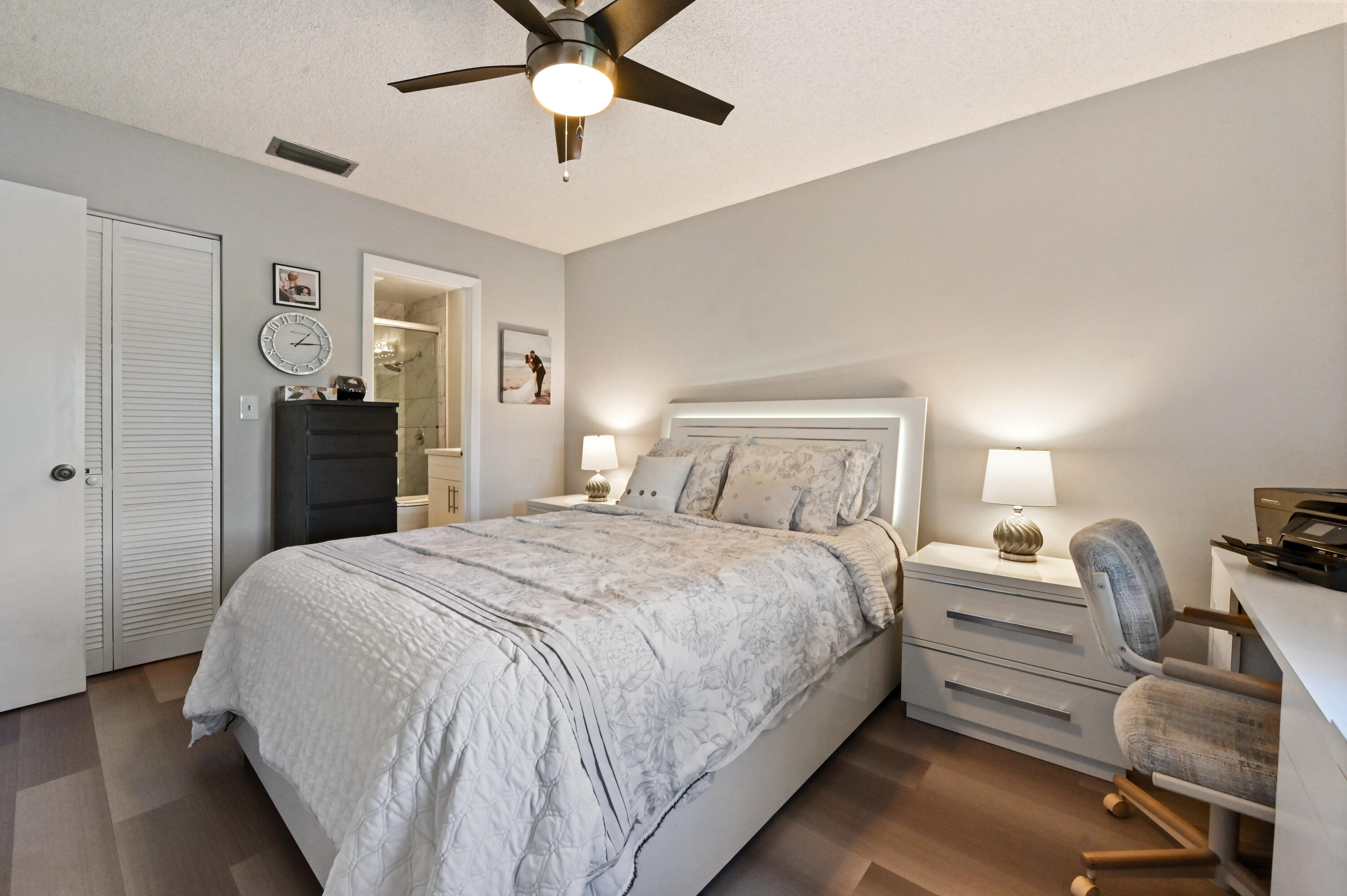 18824 Argosy Drive, Unit C Boca Raton, FL 33496 - Photo 14 of 18 a bedroom with a bed and a chandelier