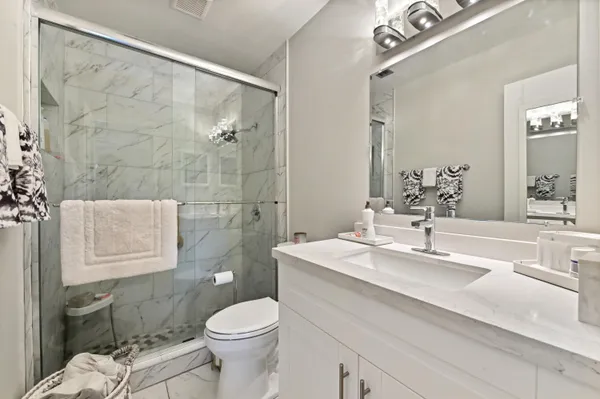 a bathroom with a sink toilet and shower