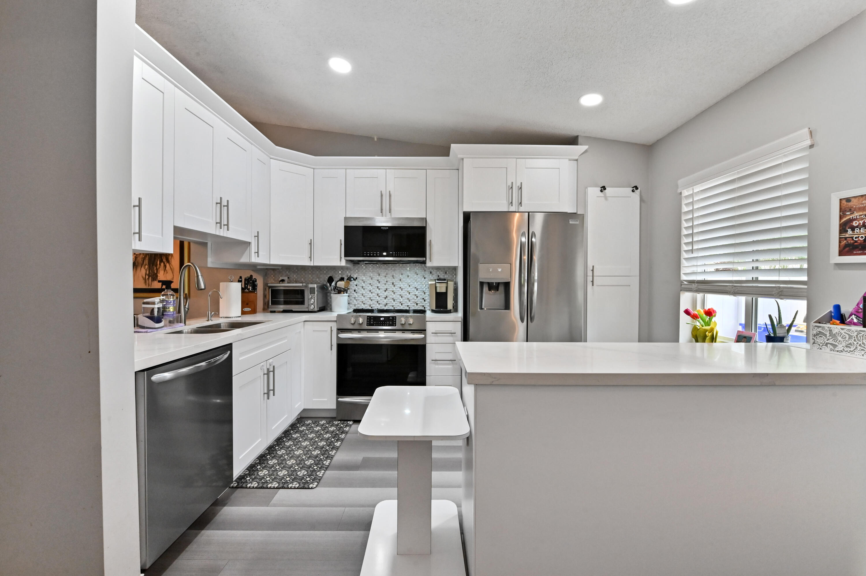 18824 Argosy Drive, Unit C Boca Raton, FL 33496 - Photo 4 of 18 a kitchen with stainless steel appliances a refrigerator sink and microwave