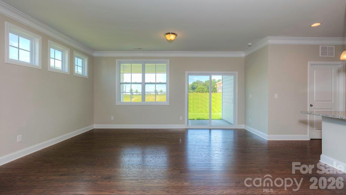 635 River Btm Road Fletcher, NC 28732 - Photo 12 of 31 a view of an empty room with wooden floor and a window