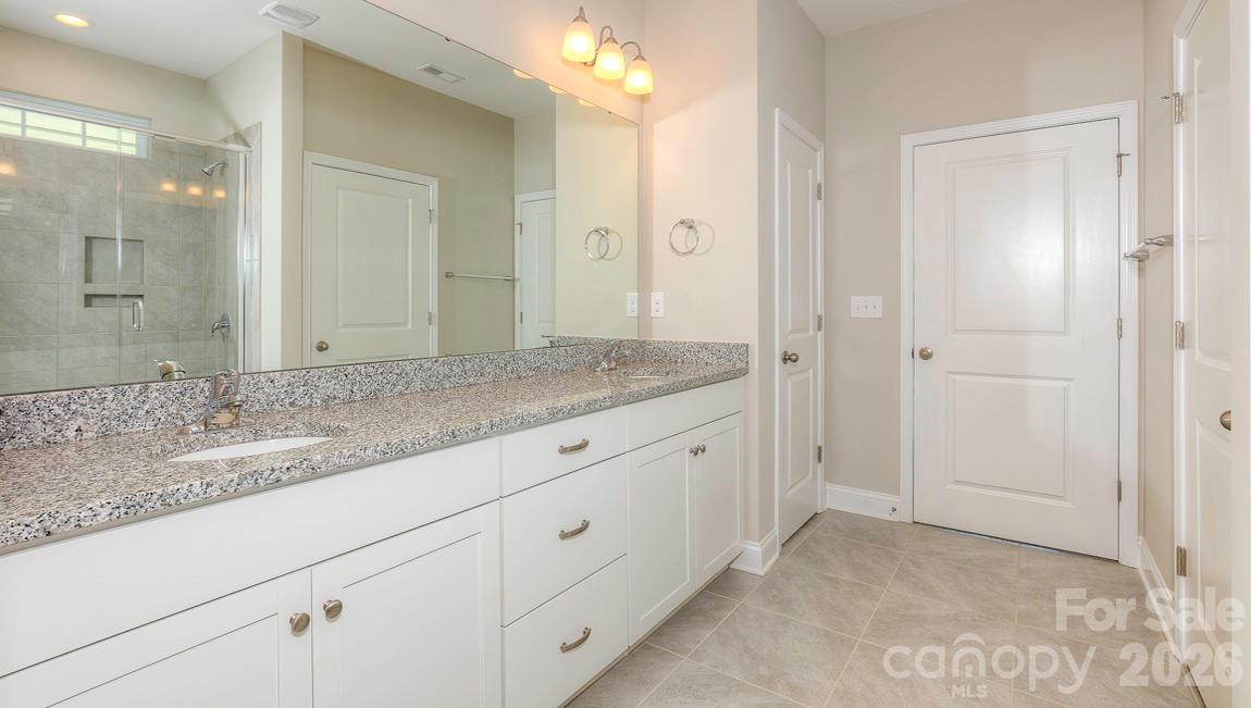 635 River Btm Road Fletcher, NC 28732 - Photo 20 of 31 a bathroom with a granite countertop sink and a mirror