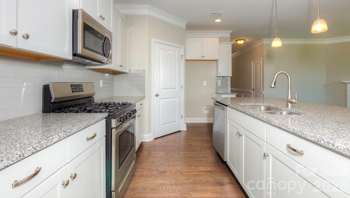 635 River Btm Road Fletcher, NC 28732 - Photo 4 of 31 a kitchen with stainless steel appliances granite countertop a sink a stove and a wooden cabinets