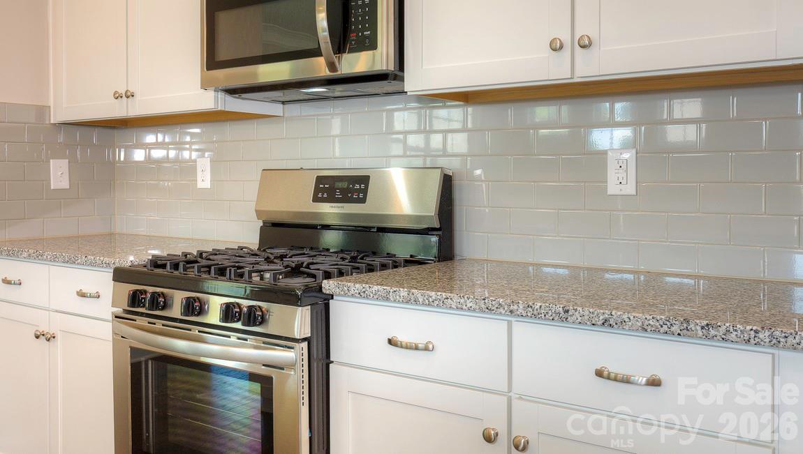 635 River Btm Road Fletcher, NC 28732 - Photo 5 of 31 a white stove top oven sitting inside of a kitchen