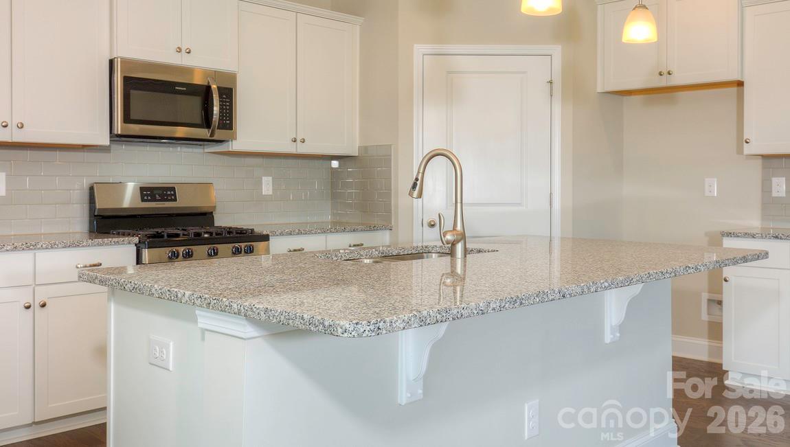 635 River Btm Road Fletcher, NC 28732 - Photo 6 of 31 a kitchen with stainless steel appliances granite countertop a sink a stove and microwave