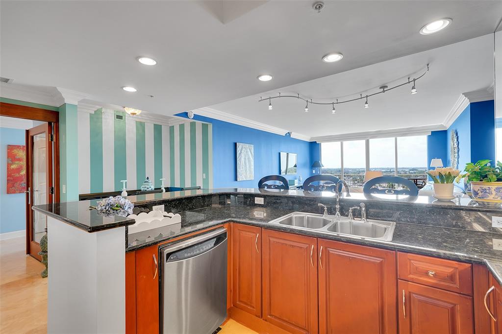 821 North Riverside Drive, Unit PH2 Pompano Beach, FL 33062 - Photo 19 of 95 a kitchen with stainless steel appliances granite countertop a sink stove and cabinets