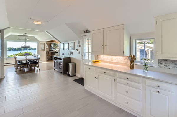 217 Barnes Road Oak Bluffs, MA 02557 - Photo 17 of 60 a large white kitchen with cabinets and a large window