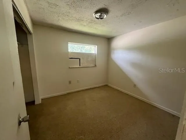 an empty room with a empty space and windows
