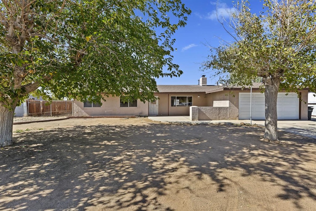 13090 Yakima Road Apple Valley, CA 92308 - Photo 1 of 1 a front view of a house with a tree