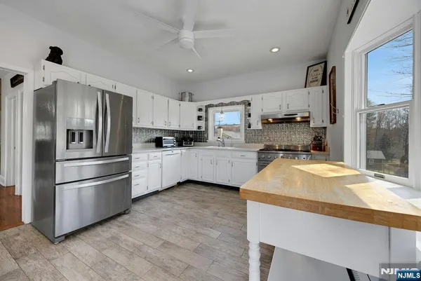 a kitchen with stainless steel appliances a refrigerator sink and microwave