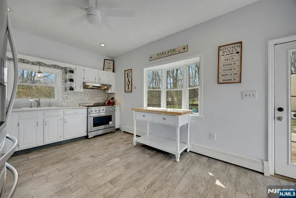 a kitchen with stainless steel appliances a stove top oven