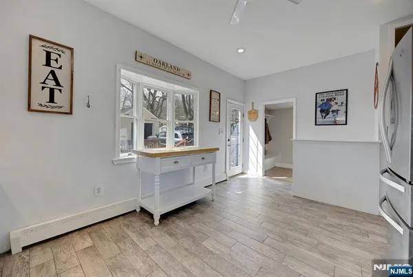 a view of a kitchen with fridge and workspace