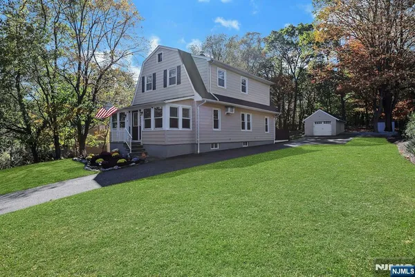 a view of a house with a yard porch and sitting area