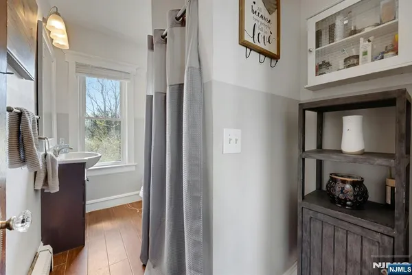 a bathroom with a sink a toilet and shower curtain