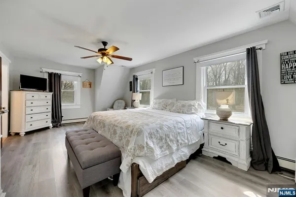 a bedroom with a bed a window and chair