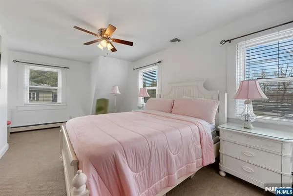 a bedroom with a bed chair and window