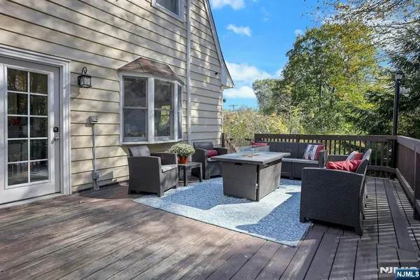 a view of a patio with couches table and chairs and potted plants