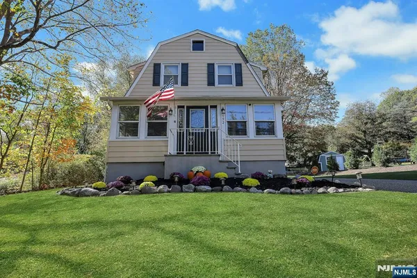 a front view of house with yard and green space
