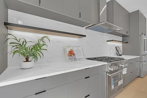 a kitchen with stainless steel appliances granite countertop a sink and a stove