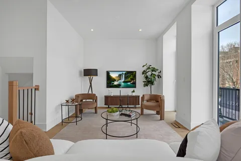 a view of a workspace room with wooden floor and a window