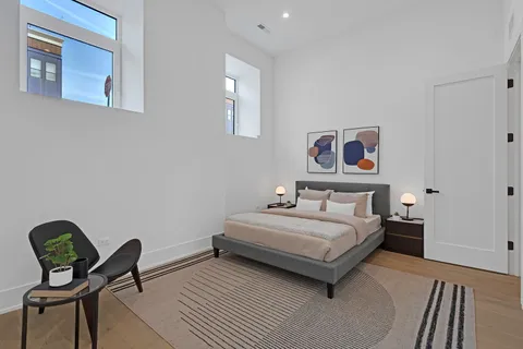 a bedroom with a bed and a chandelier