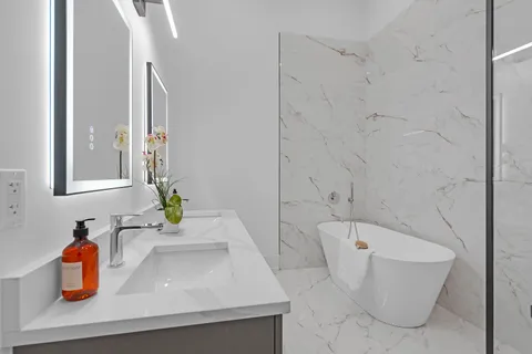 a bathroom with a bathtub and shower