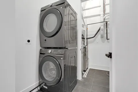 a bathroom with a shower sink vanity mirror and toilet