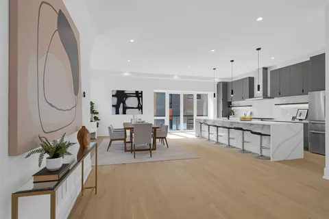 a living room with furniture a fireplace and a potted plant