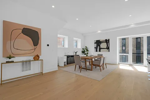 a living room with furniture a rug and a dining table