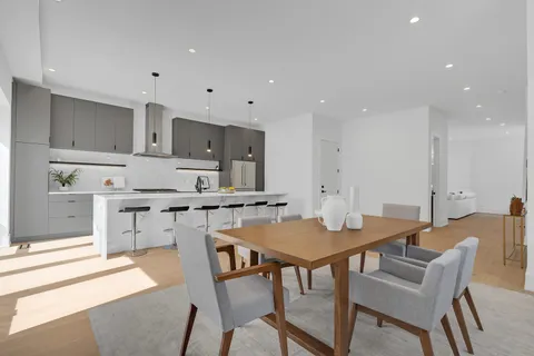 a kitchen with stainless steel appliances granite countertop a sink a stove and a refrigerator