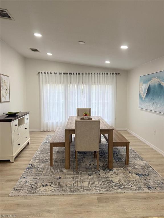27579 Big Bend Road Bonita Springs, FL 34134 - Photo 3 of 9 a dining room with furniture a rug and wooden floor