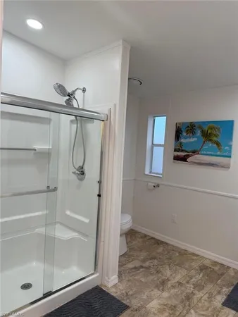a bathroom with a glass shower door
