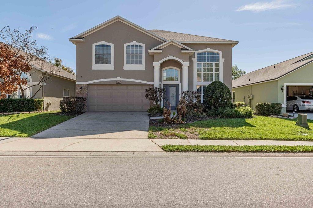 7018 Cascade Court Lakeland, FL 33813 - Photo 1 of 31 a front view of a house with a yard and garage
