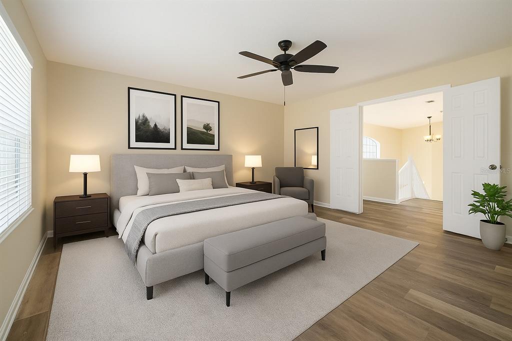 7018 Cascade Court Lakeland, FL 33813 - Photo 11 of 31 a bedroom with a large bed and a chandelier