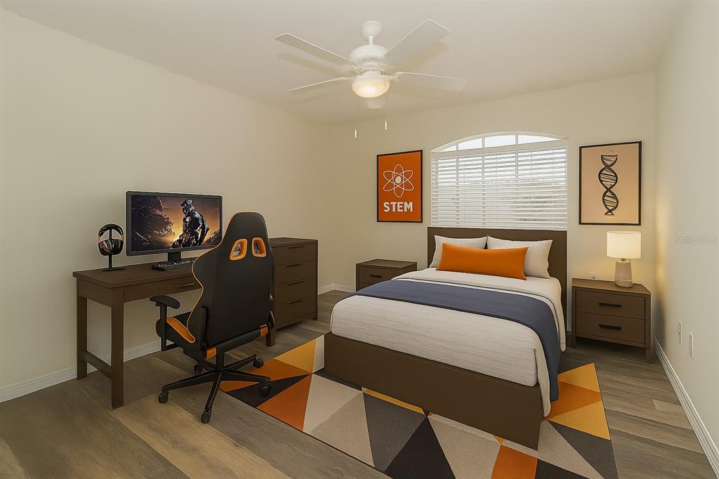 7018 Cascade Court Lakeland, FL 33813 - Photo 15 of 31 a bedroom with a bed and a desk